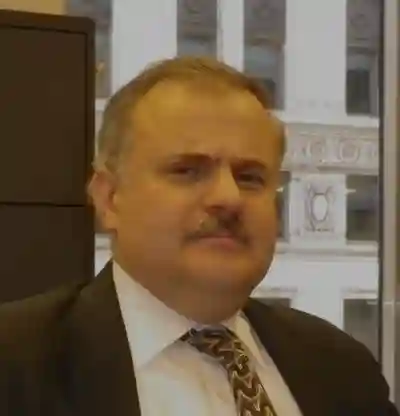 Headshot of man in business suit.